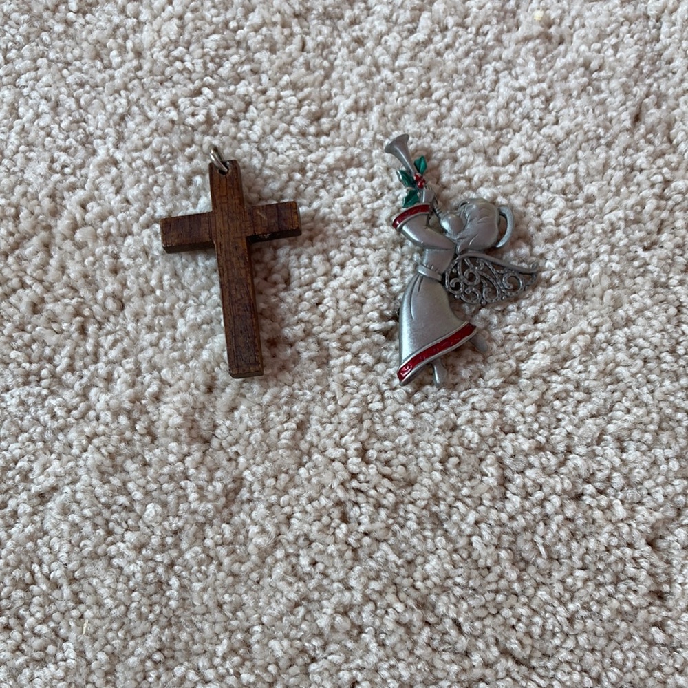 I’m selling a cross that can go on a necklace and an angel blowing a horn pin